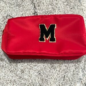 Red cosmetic bag new without tags with capital M. Never used.